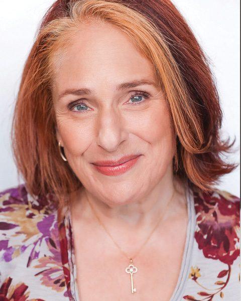 Joy Hermalyn plays Beulah in Come From Away she is a white female with red hair with streaks differing reds.